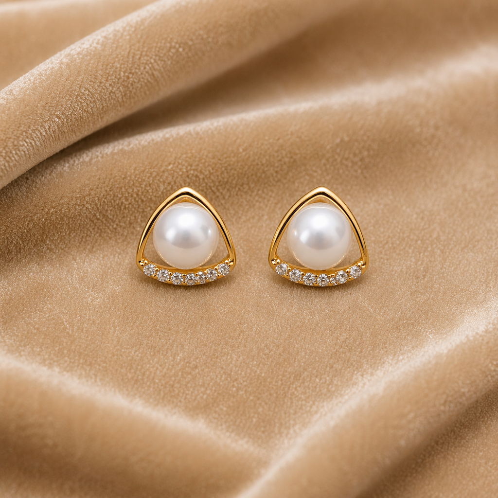 pearl centerpiece gold stud earrings on velvet