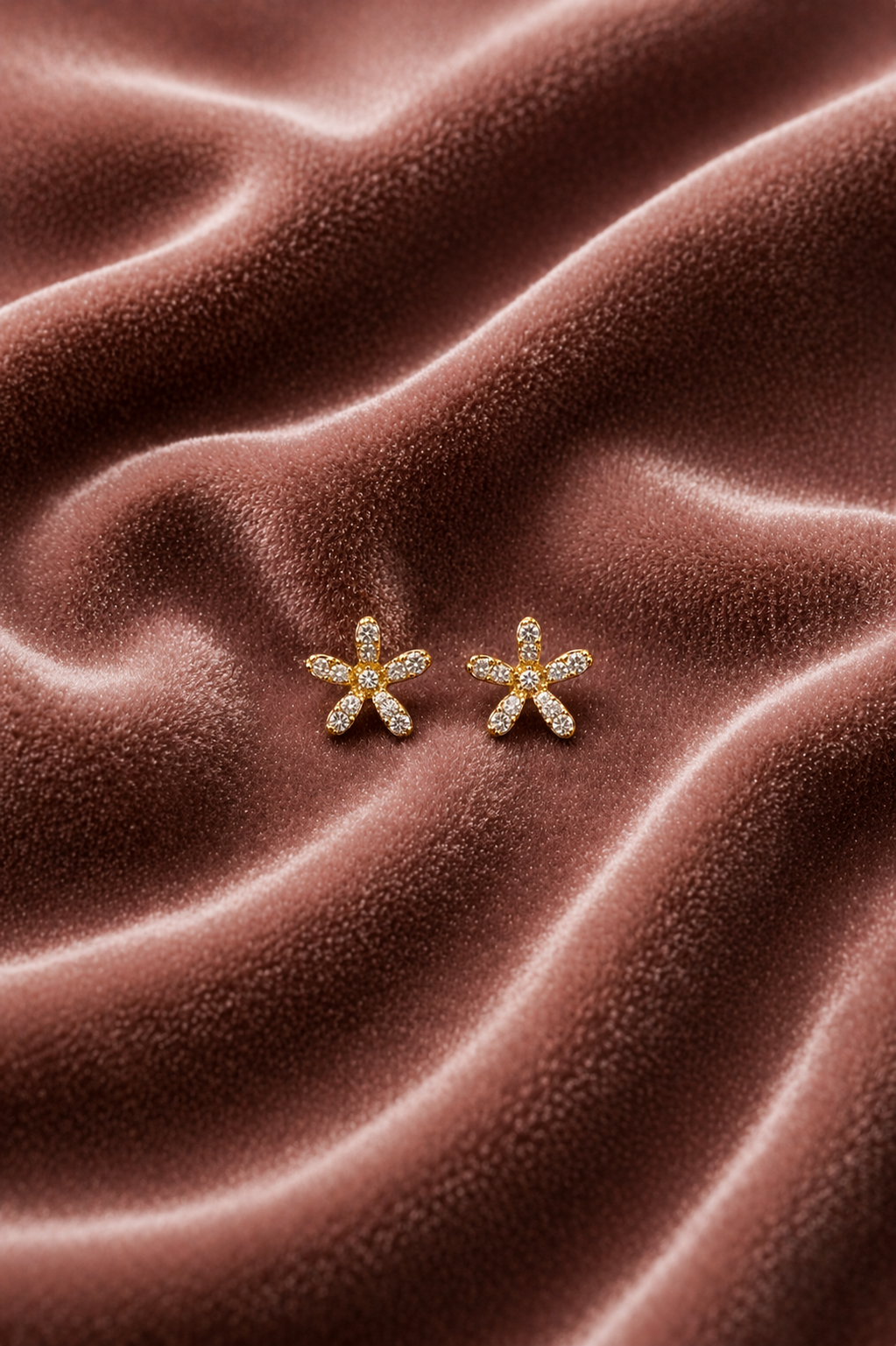 sparkling stones gold stud earrings on velvet

