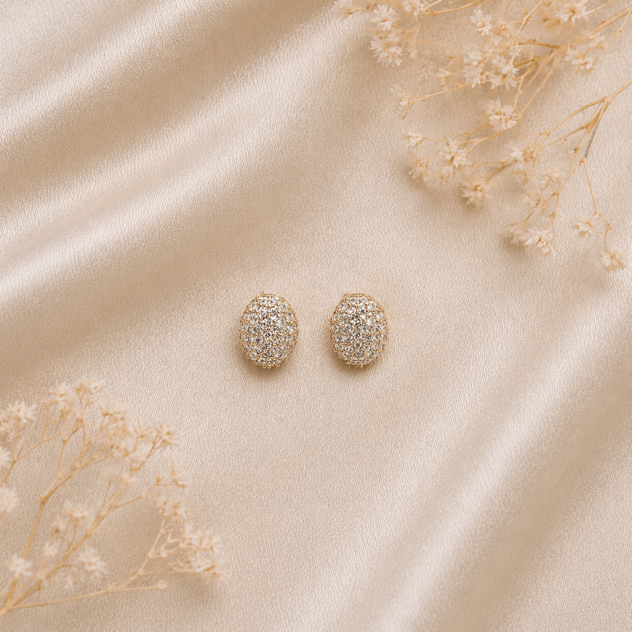 Statement shimmering stones stud earrings on satin