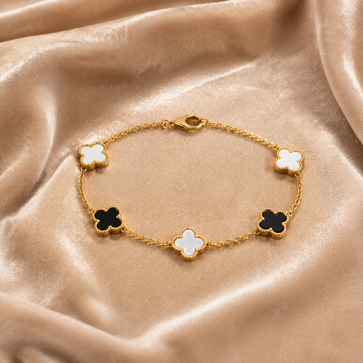 black and white clover gold bracelet on velvet
