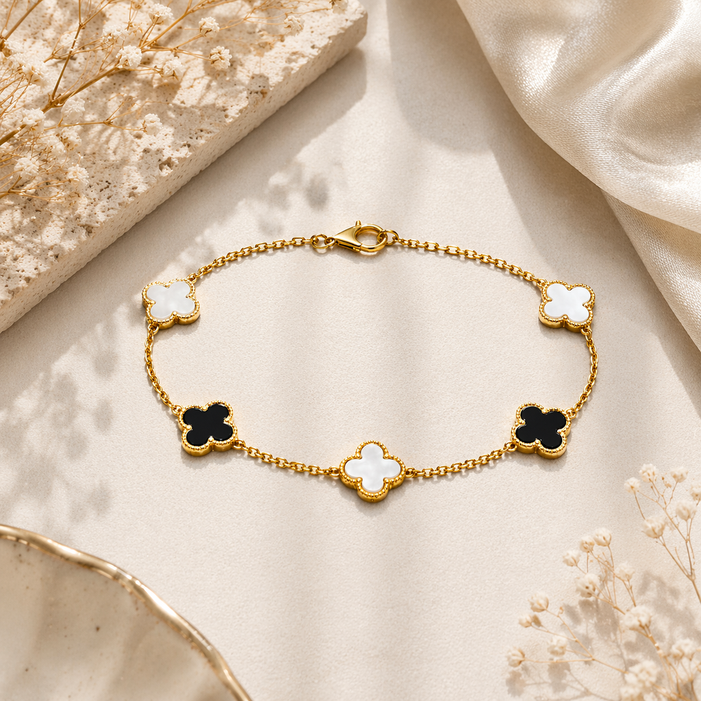 black and white clover gold bracelet on marble 