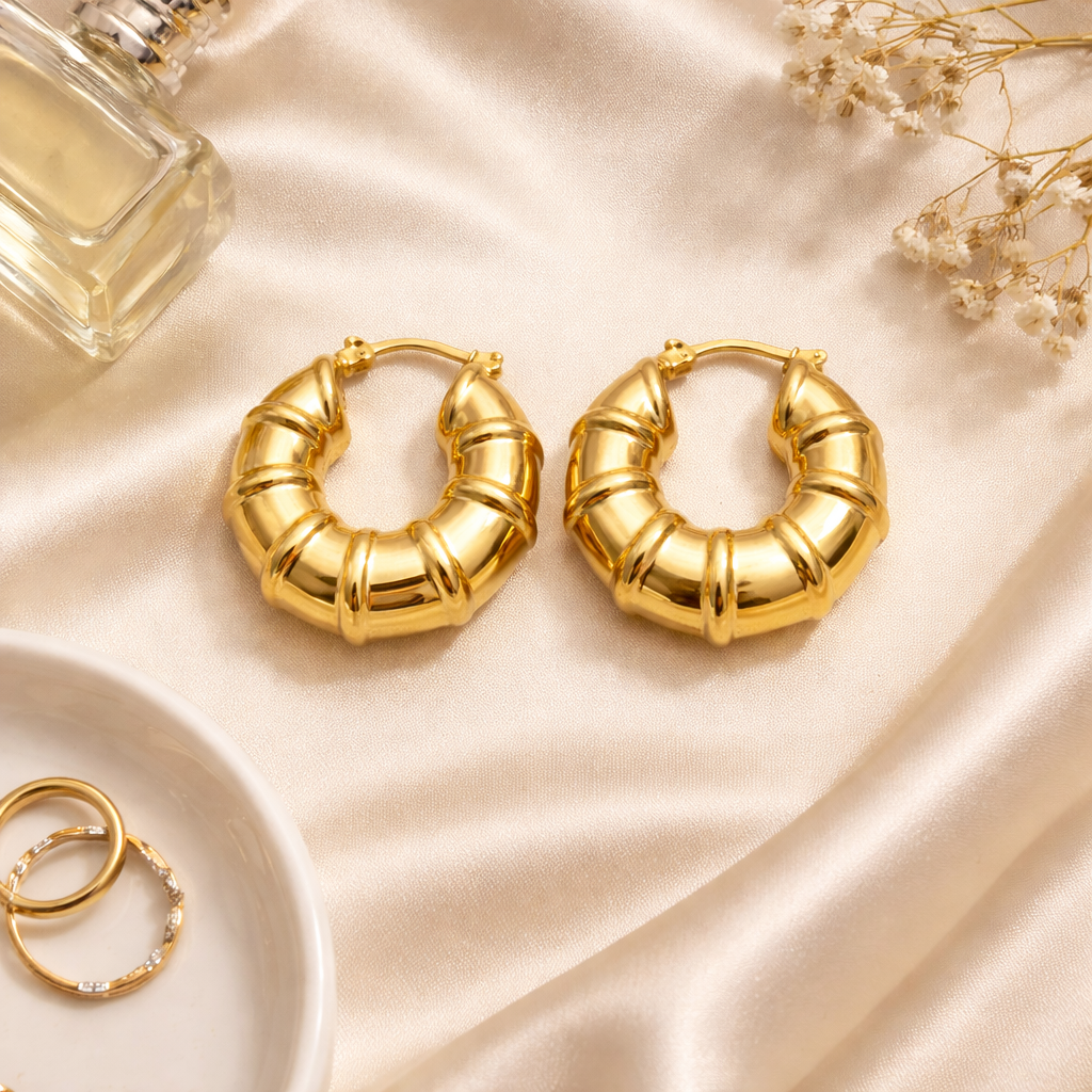 Ribbed design gold hoop earrings on satin