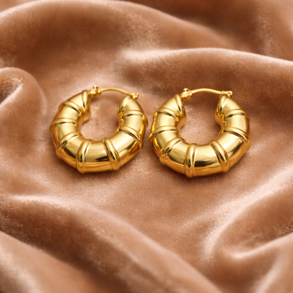 Ribbed design gold hoop earrings on velvet