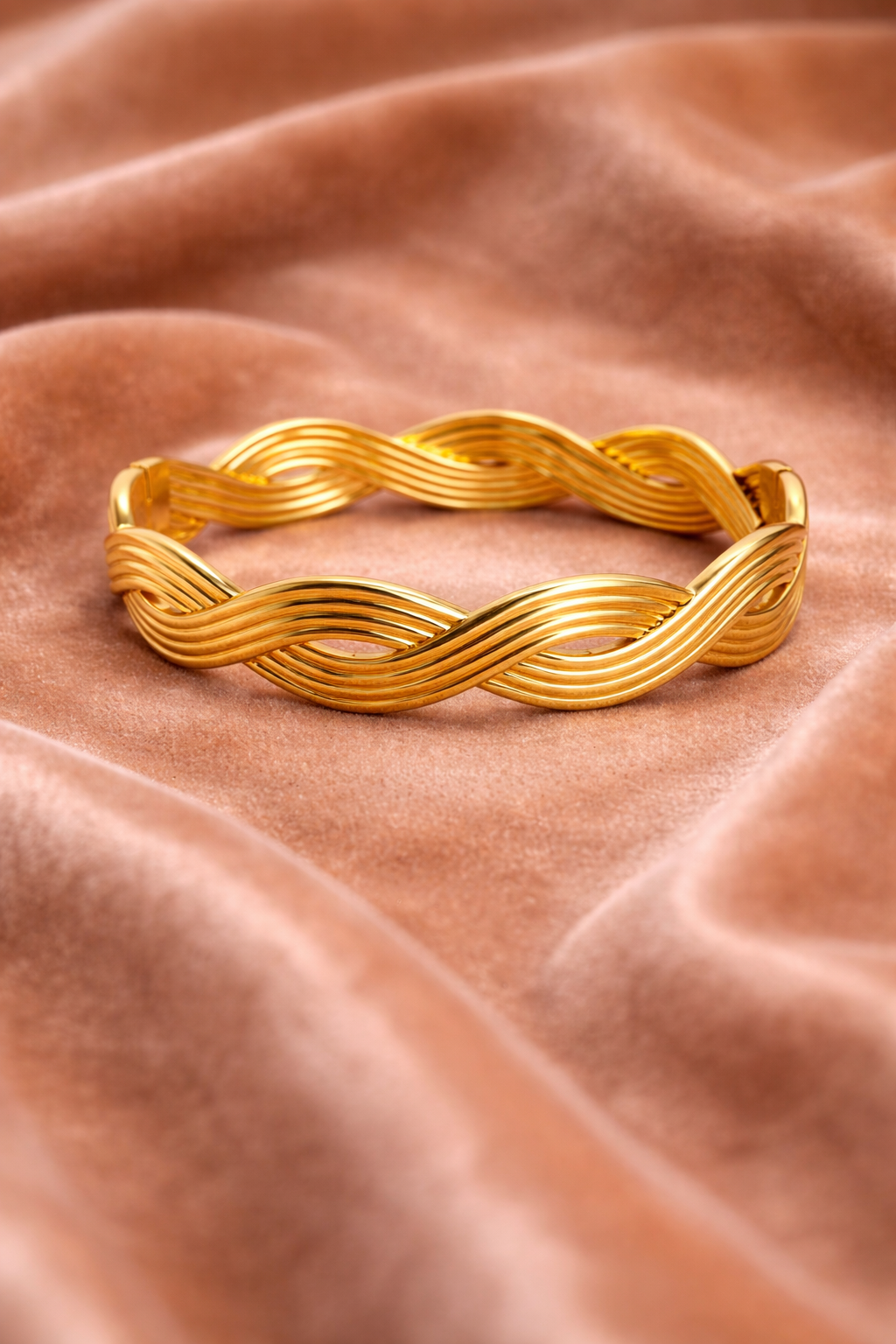 Wave design gold cuff bracelet on velvet