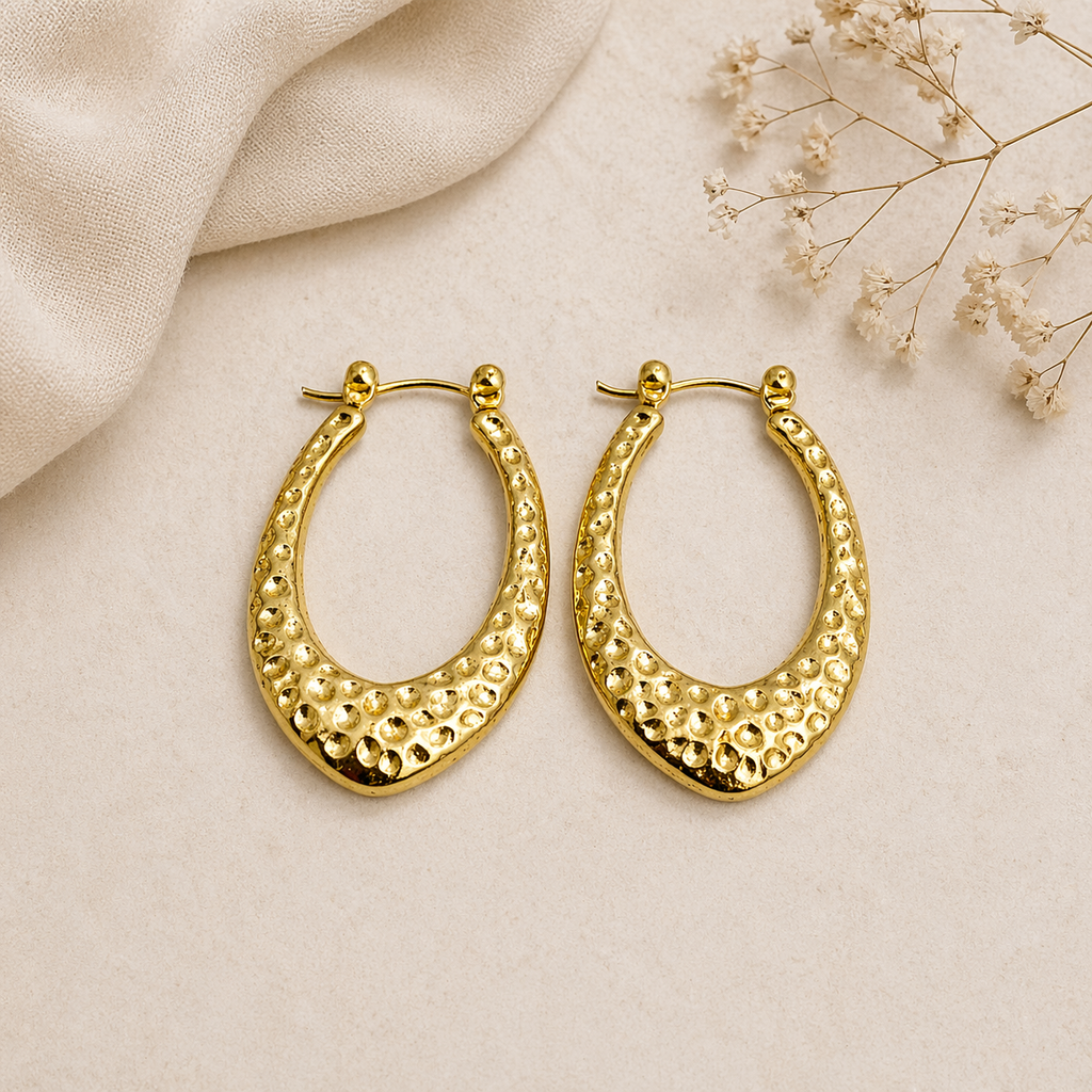  Teardrop gold hoop earrings on marble