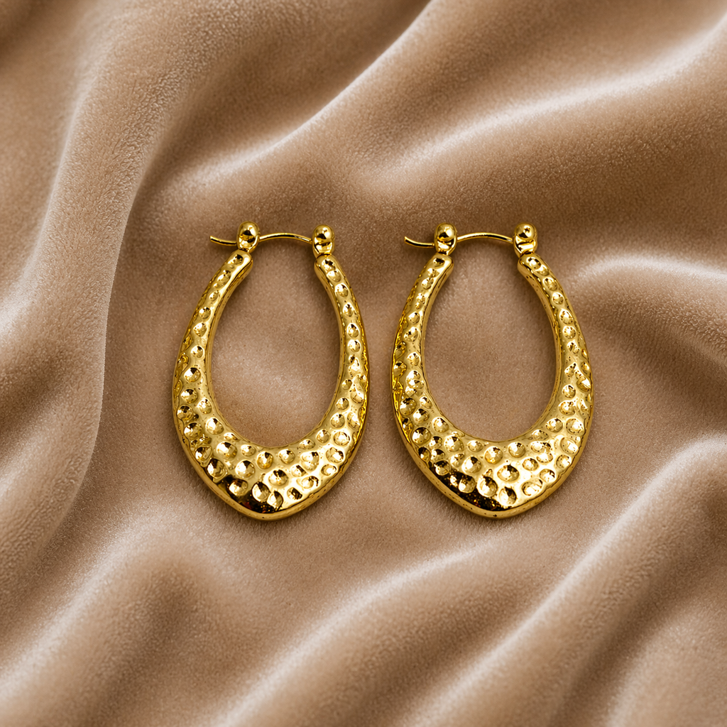  Teardrop gold hoop earrings on velvet