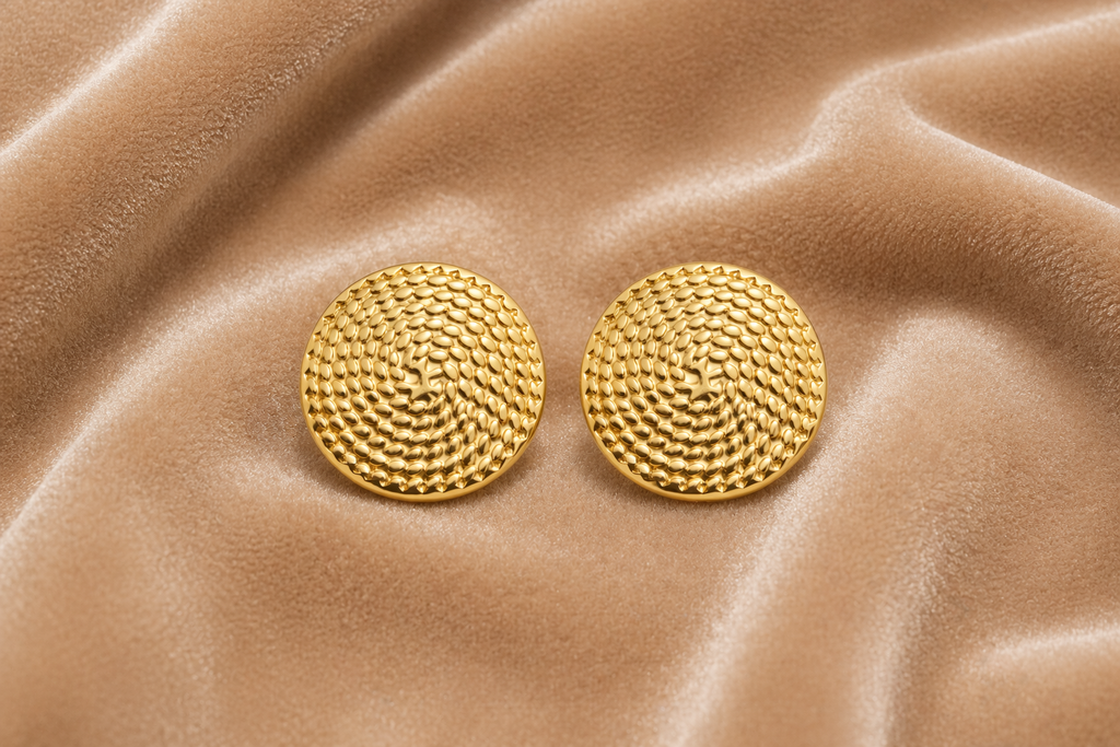 Round textured gold stud earrings on velvet