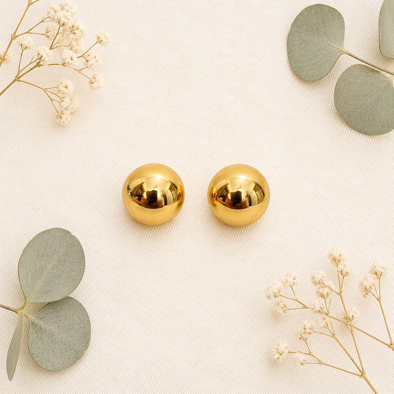 Ball stud earrings on flat