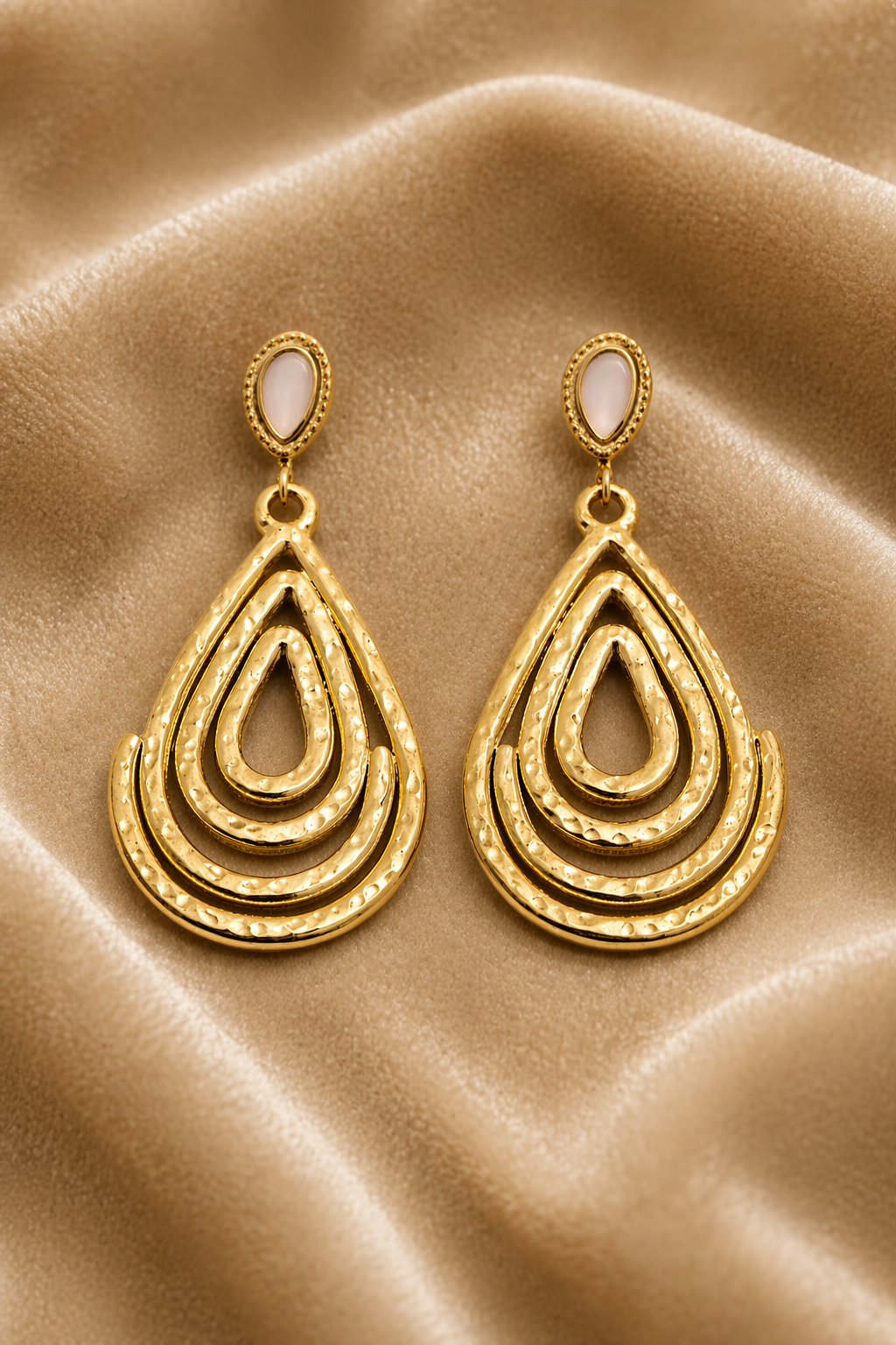 Gold drop earrings on velvet