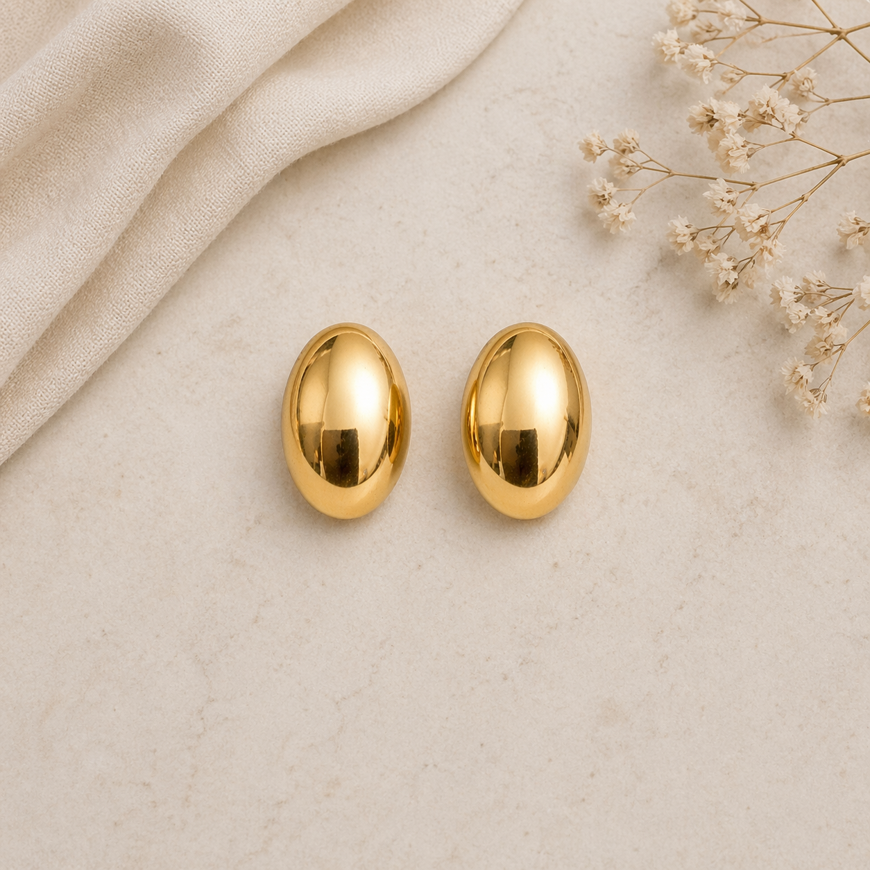 Oval stud earrings on marble