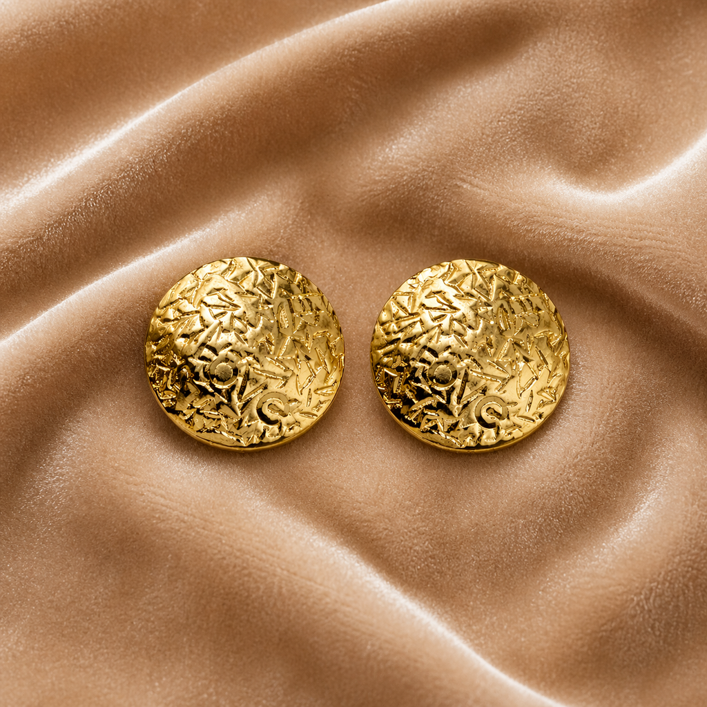 Classic round gold stud earrings on velvet
