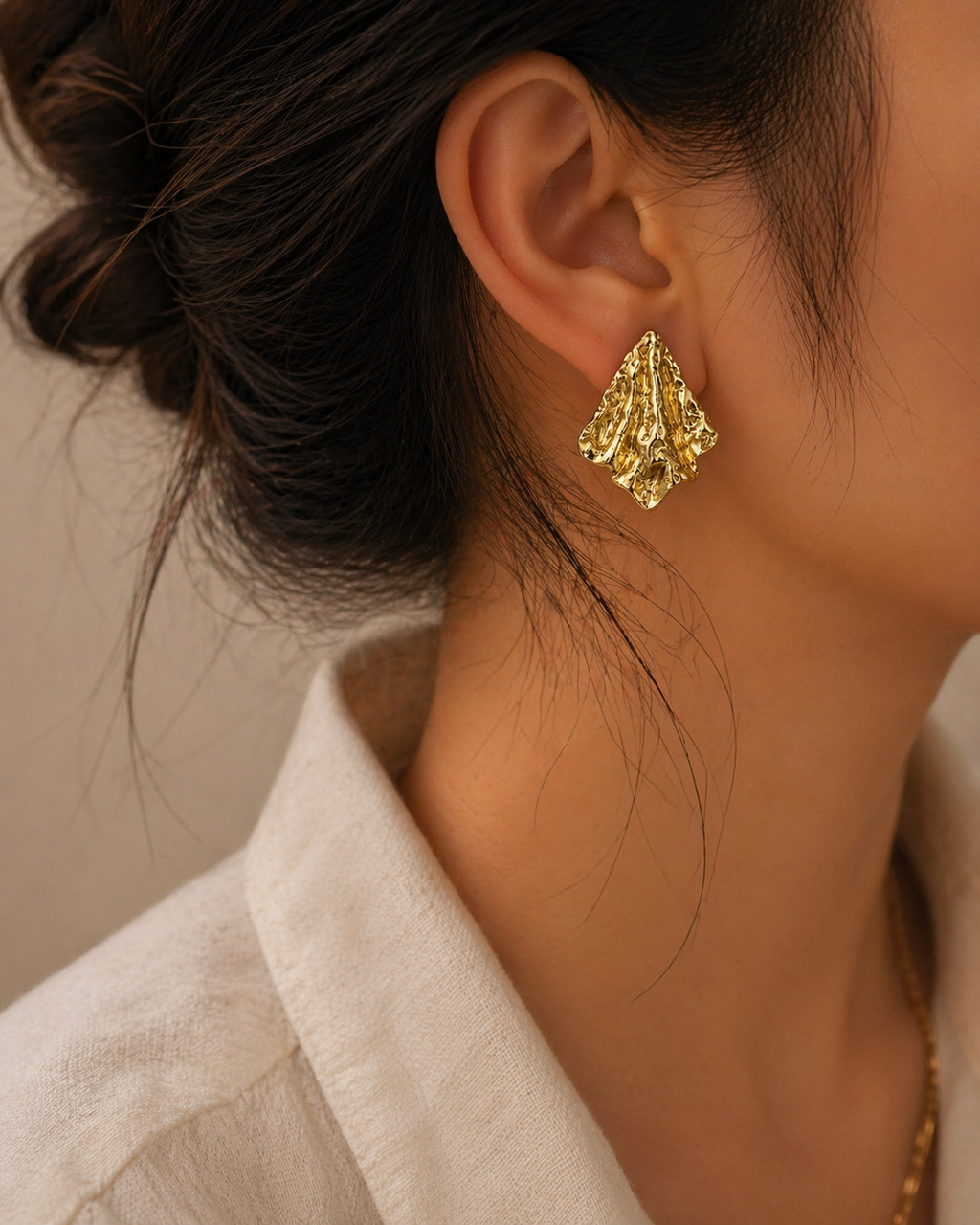 Elegant gold textured stud earrings on trial