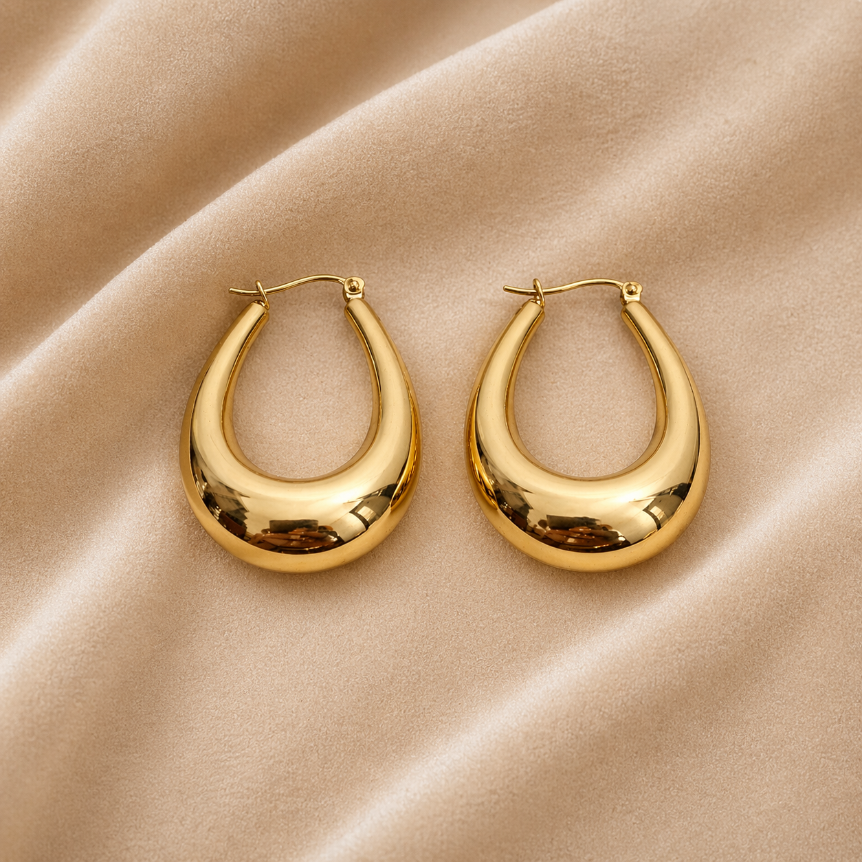 Bold gold hoop earrings on velvet