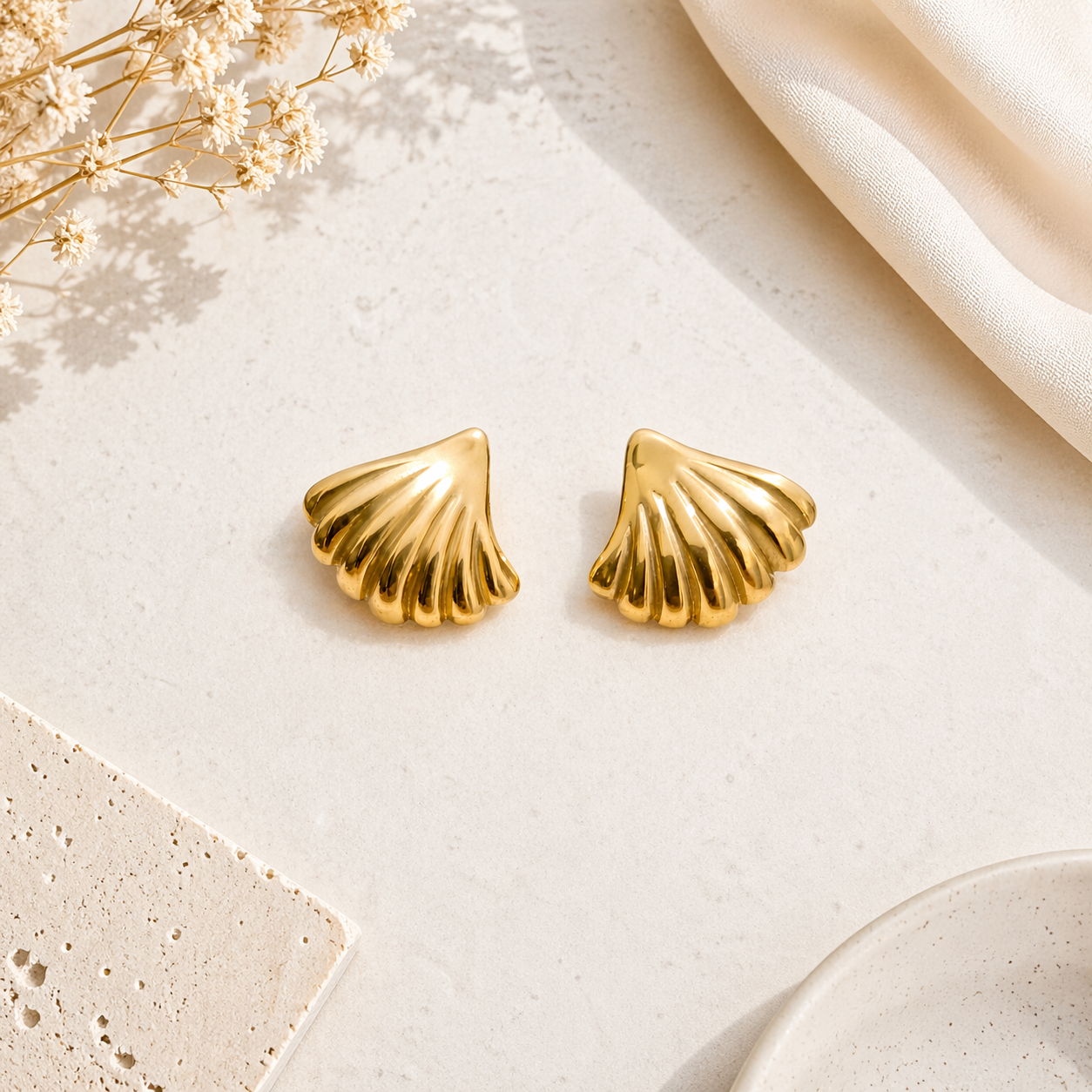 Shell stud earrings on marble 