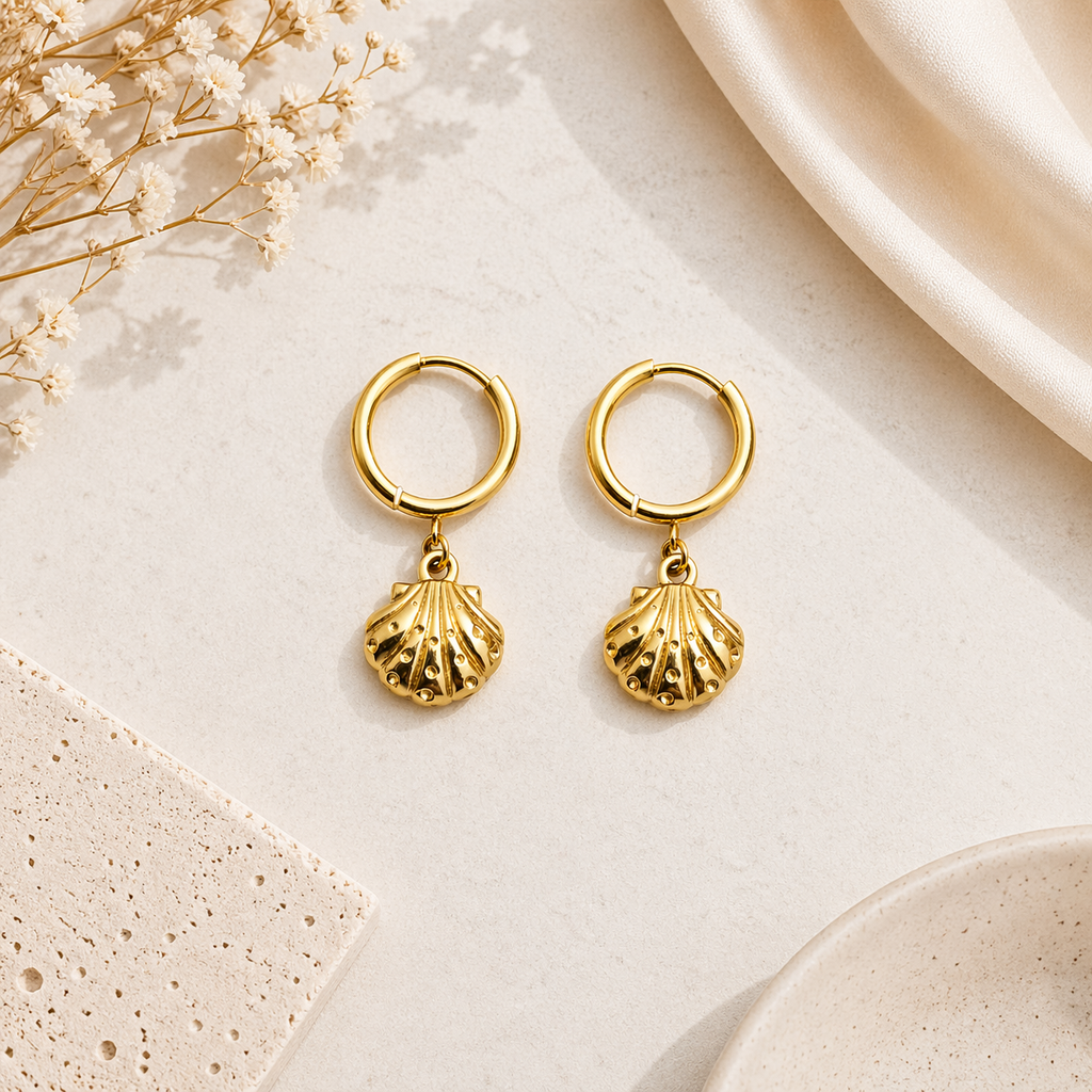 Shell charm hoop earrings on marble 