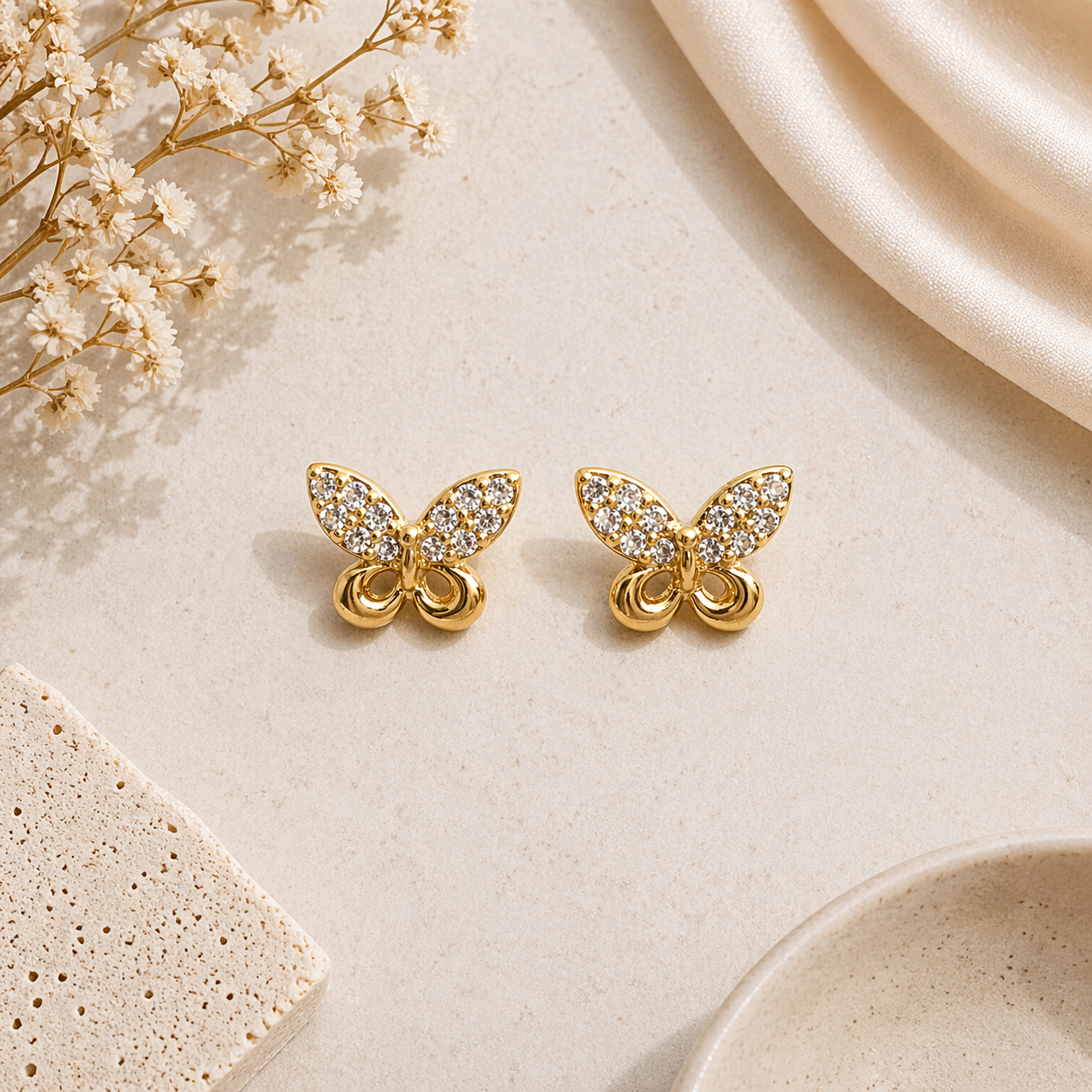 Butterfly stud earrings on marble