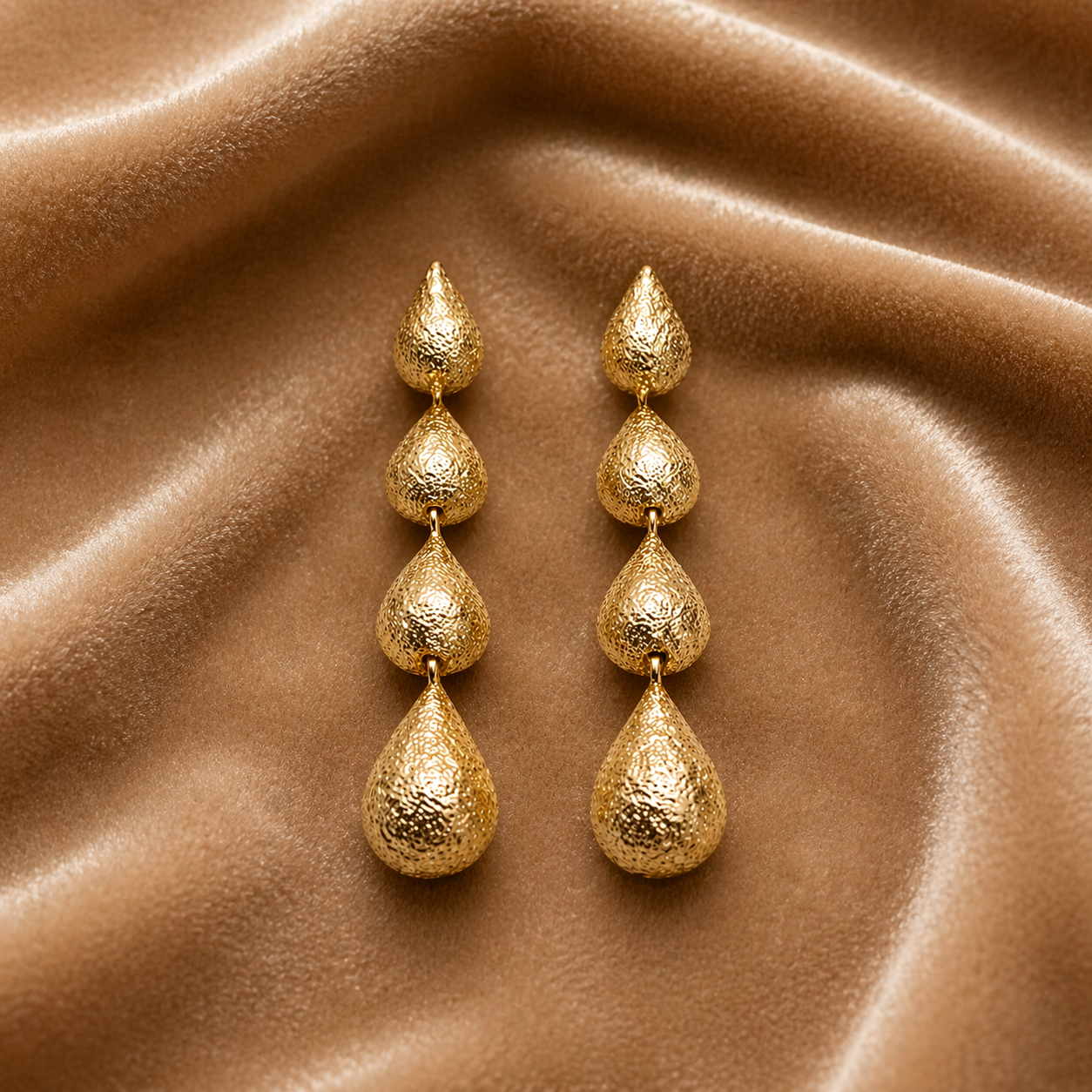  Layered gold drop earrings on velvet