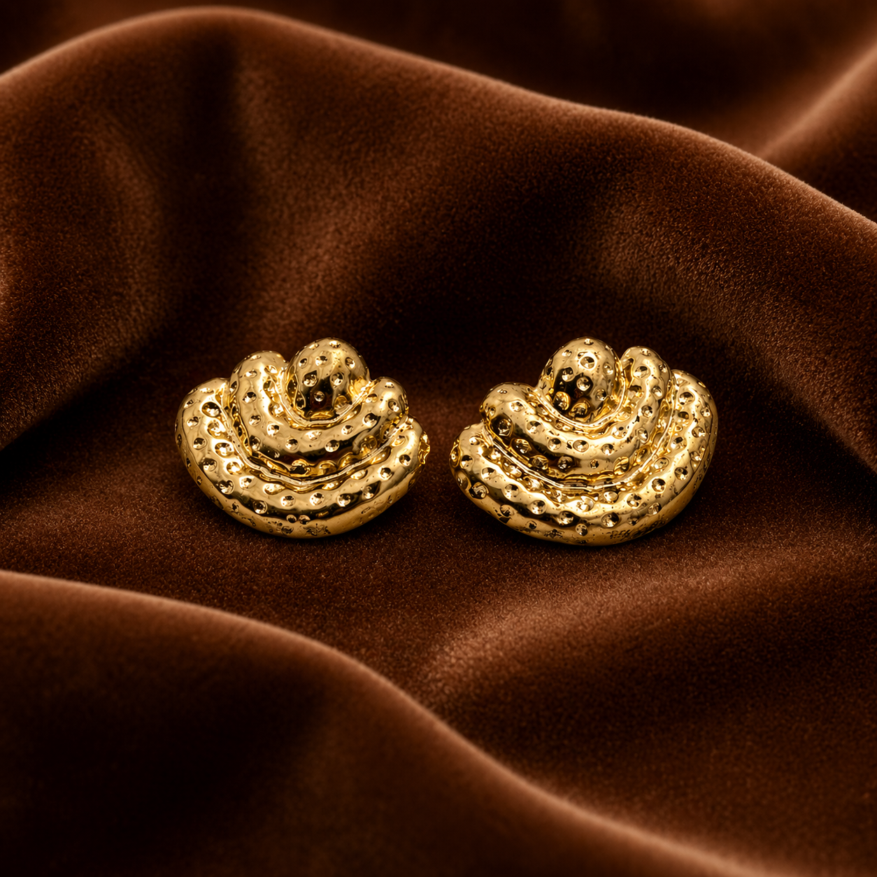 Layered textured stud earring on velvet