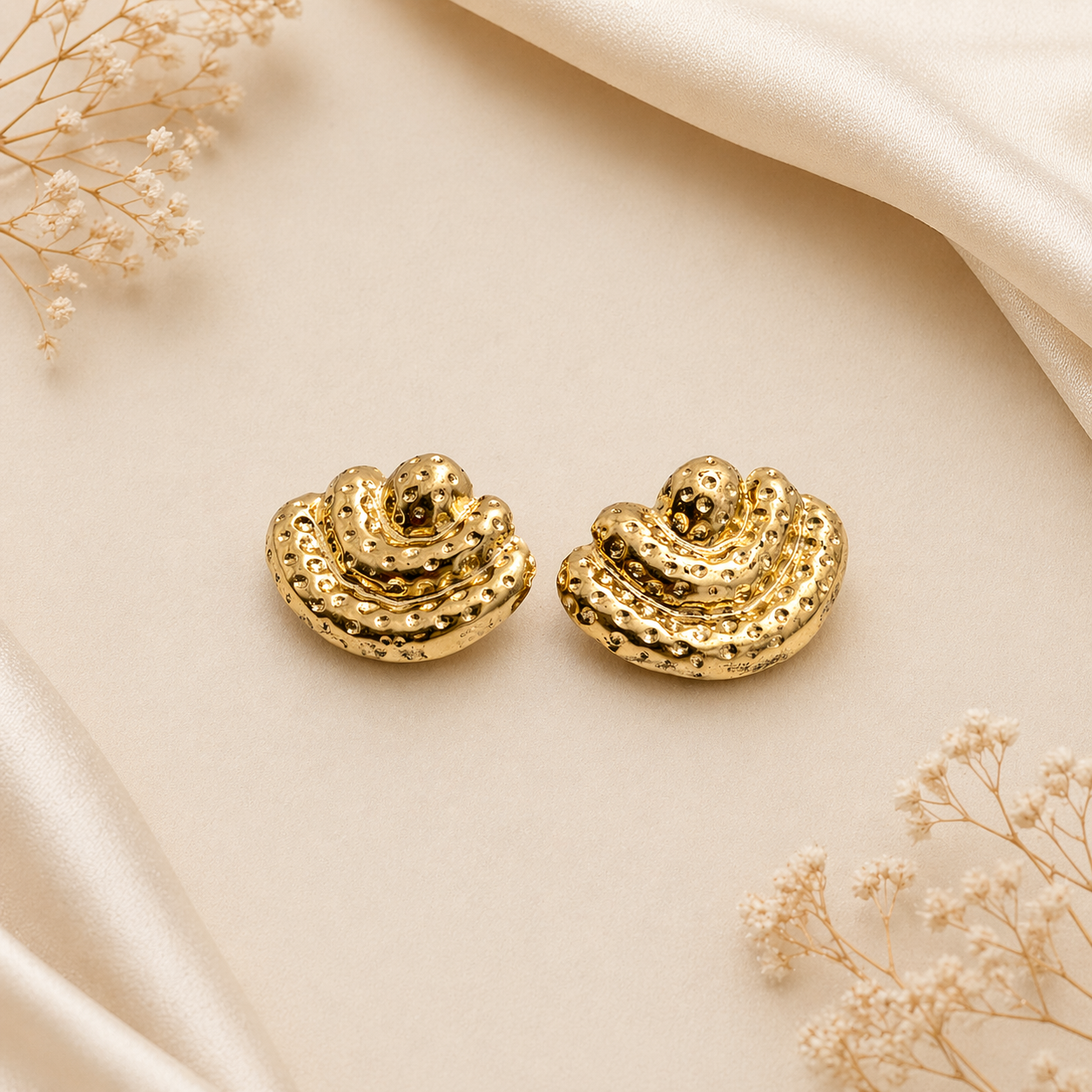 Layered textured stud earring on marble