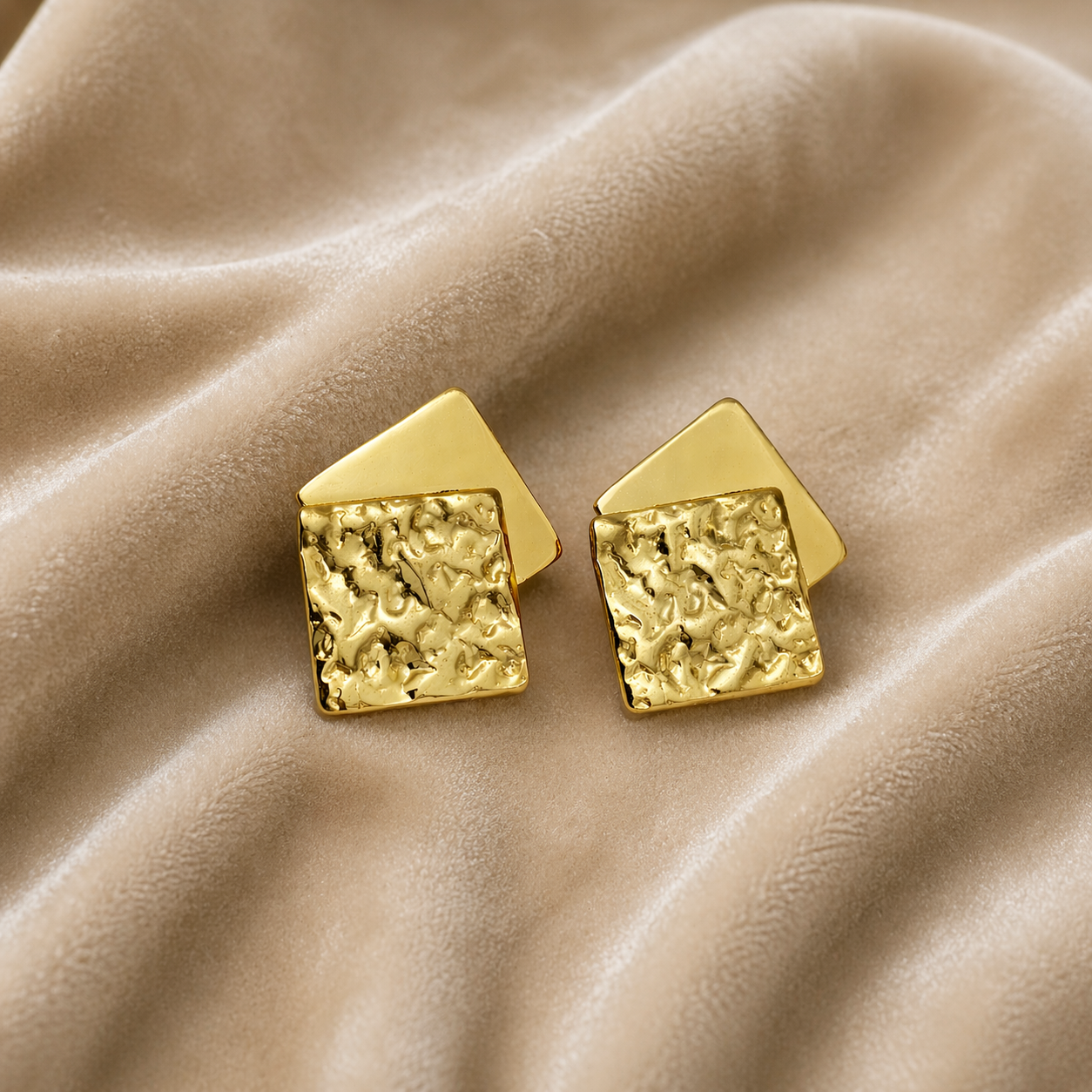 Layered square stud earrings on velvet