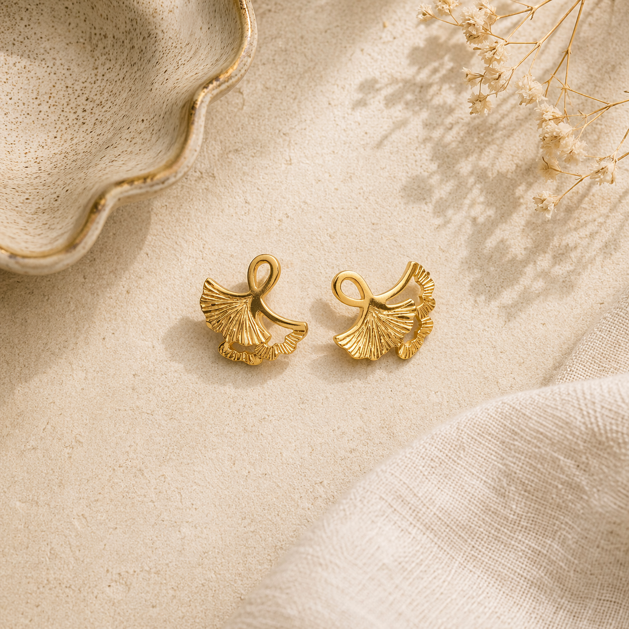 Chic gold stud earrings on marble