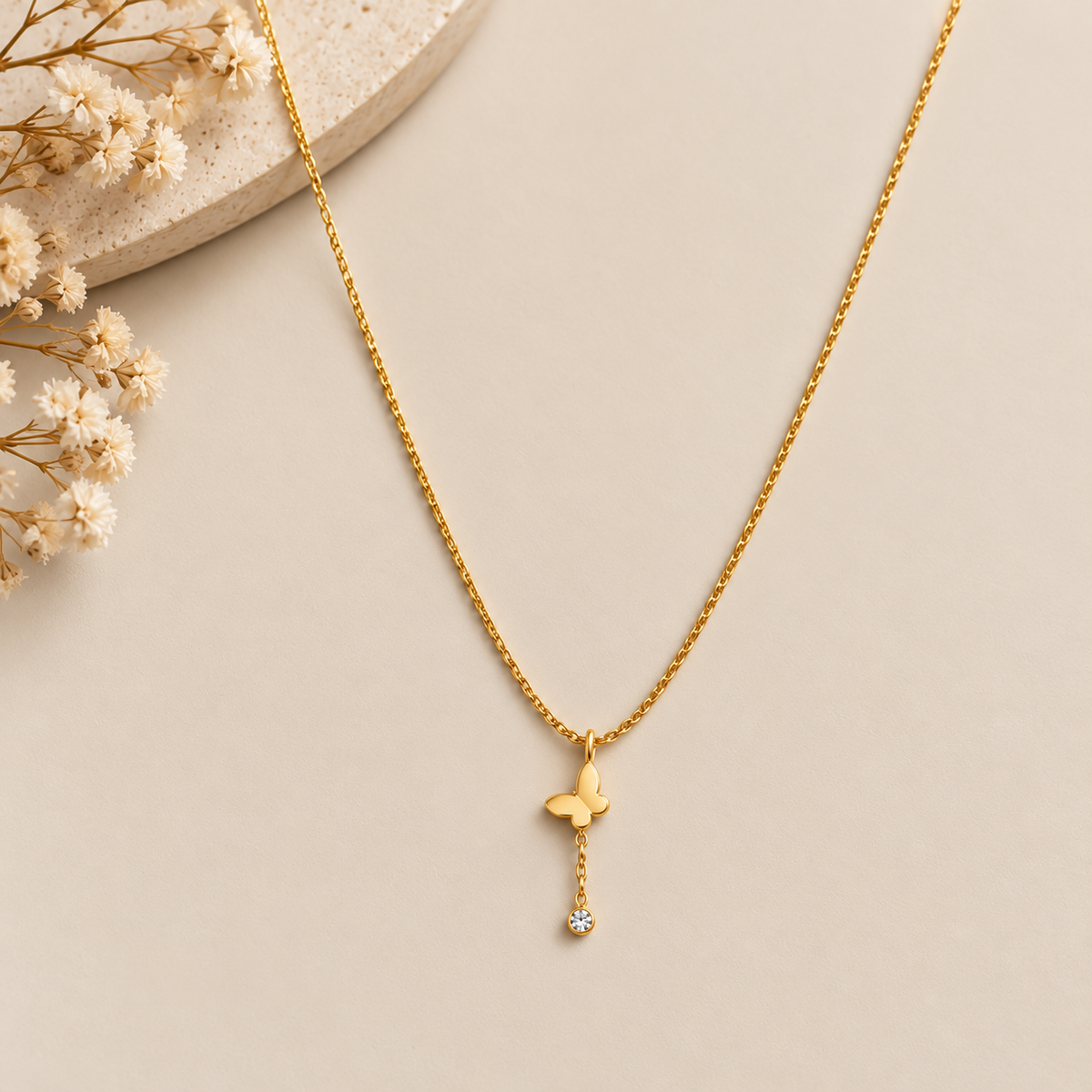 Gold Butterfly Pendant Necklace with Crystal Drop on flat lay