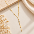  Gold Floral Y-Lariat Necklace on flat lay