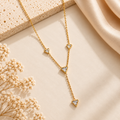 Gold Triangular Crystal Necklace on flat lay
