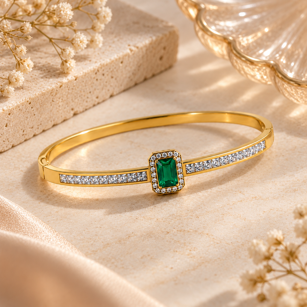 Emerald Green Crystal Gold-Tone Bangle Bracelet on flat lay