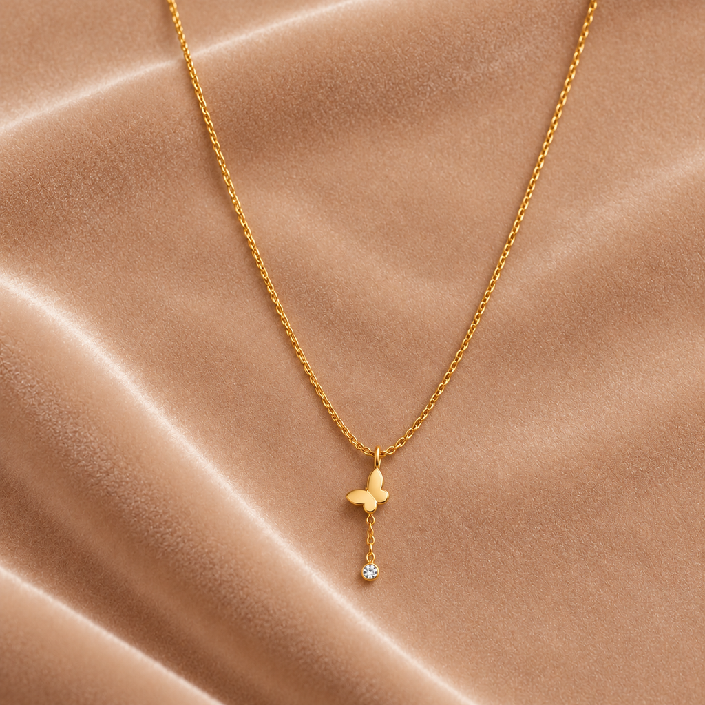 Gold Butterfly Pendant Necklace with Crystal Drop on velvet