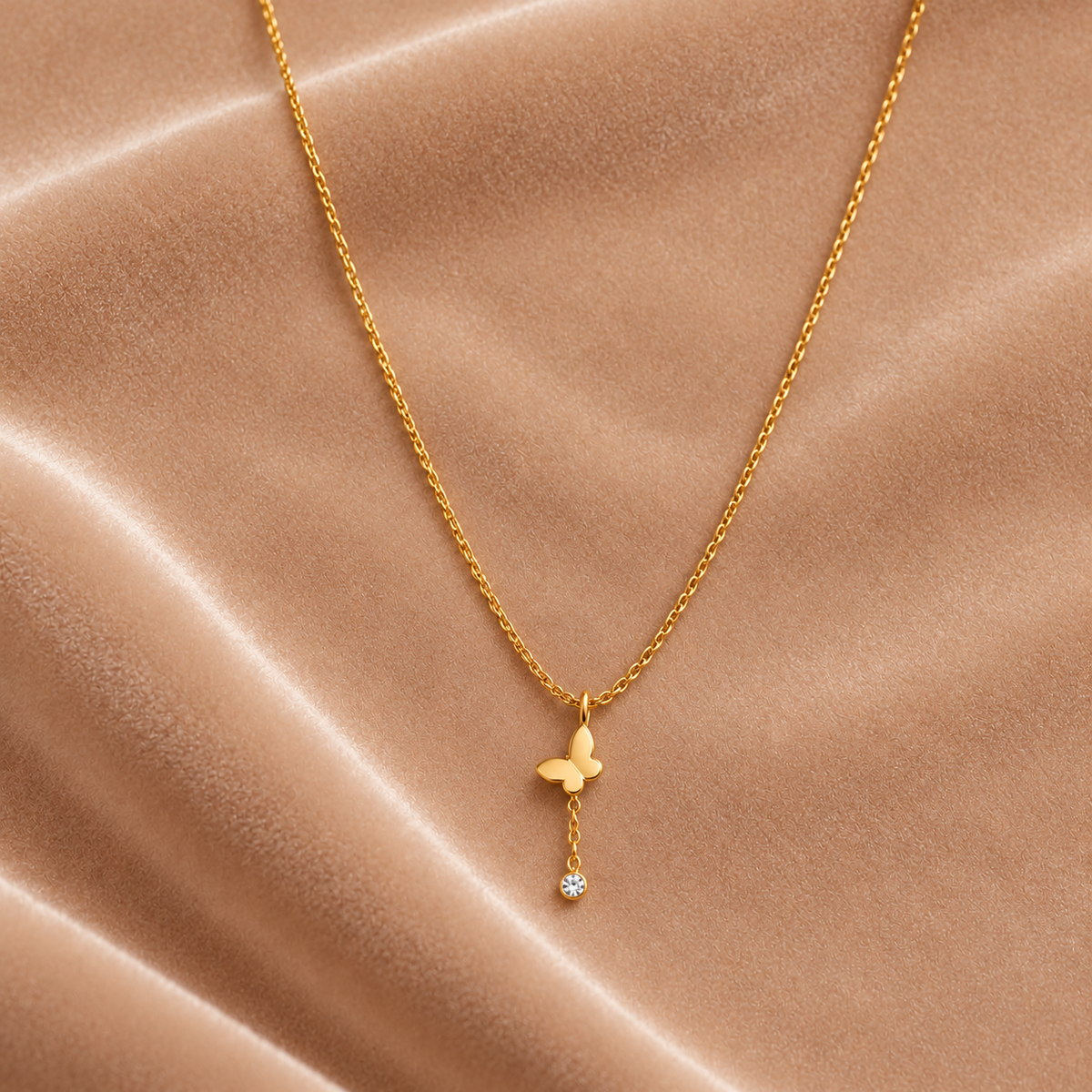 Gold Butterfly Pendant Necklace with Crystal Drop on velvet