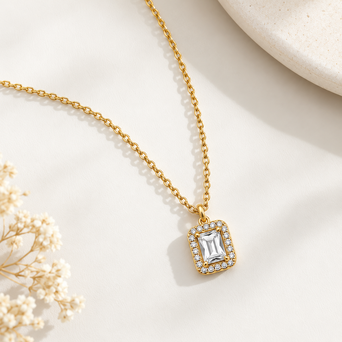Emerald Cut Halo Pendant Necklace on flat lay 