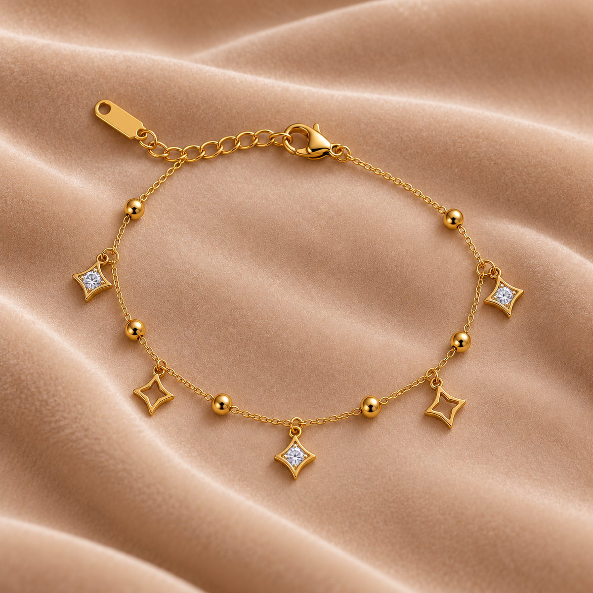 Gold Star Charm Bracelet with Crystal Accents on velvet