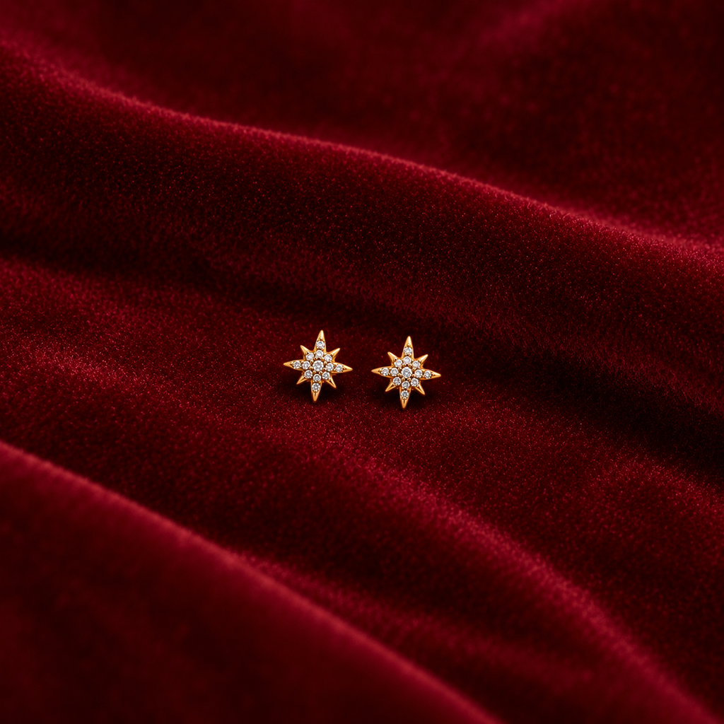 Gold Starburst Stud Earrings on velvet