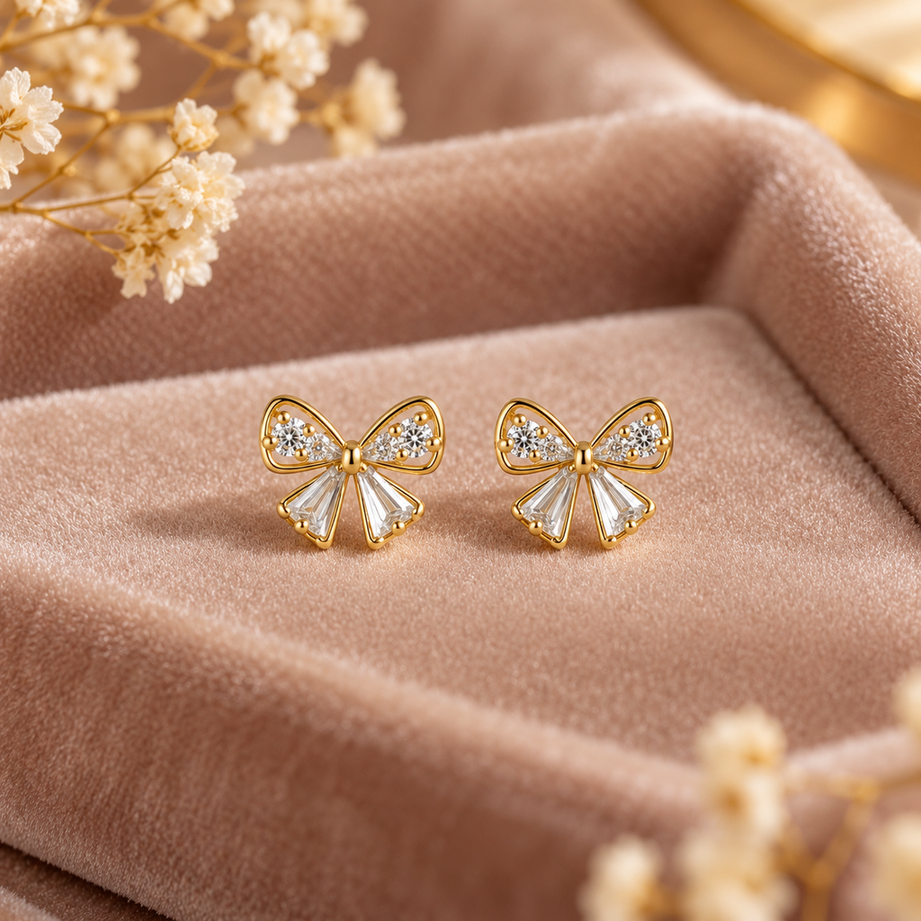 Dainty Gold Bow Stud Earrings on velvet