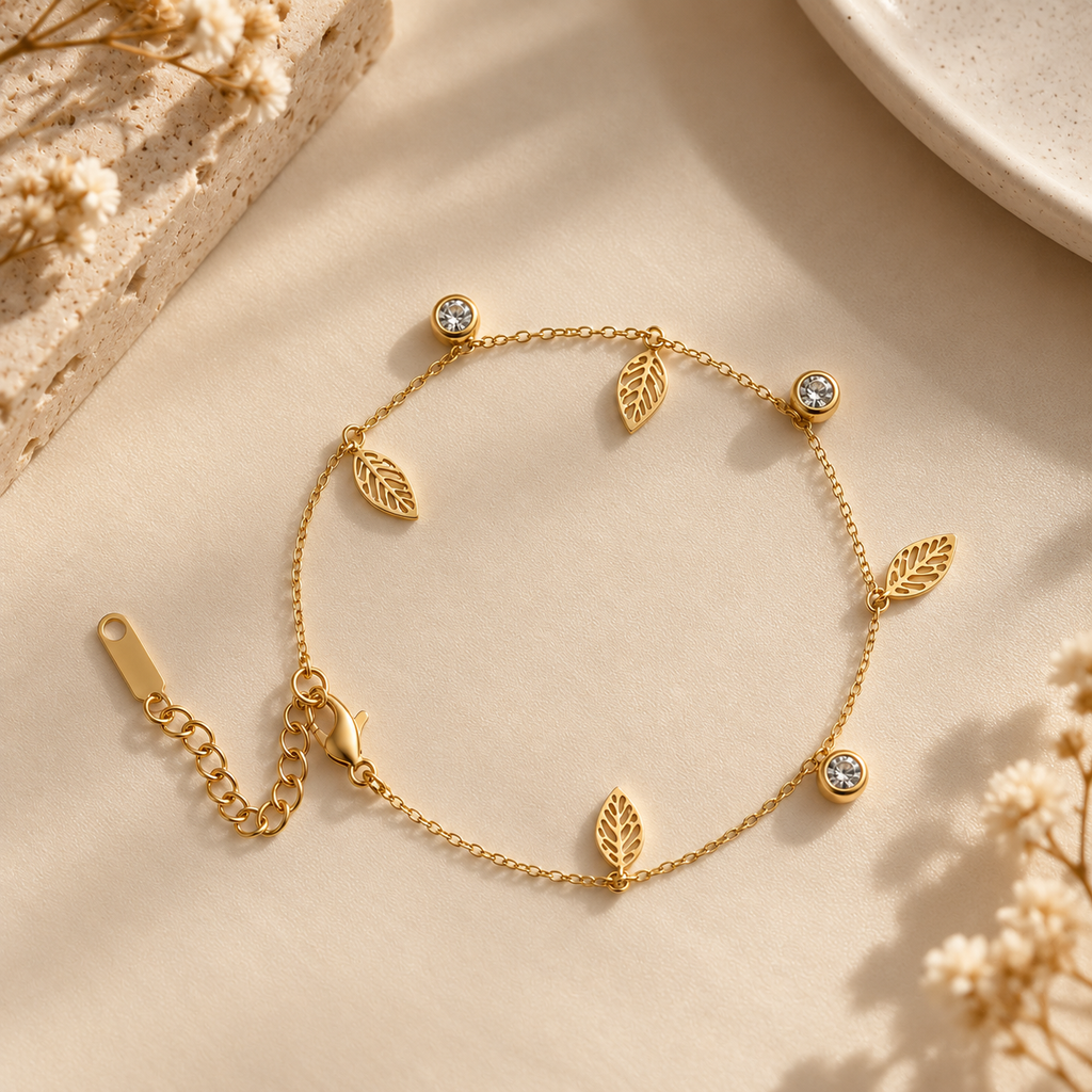 Gold Leaf Charm Bracelet with Crystal Accents on flat lay