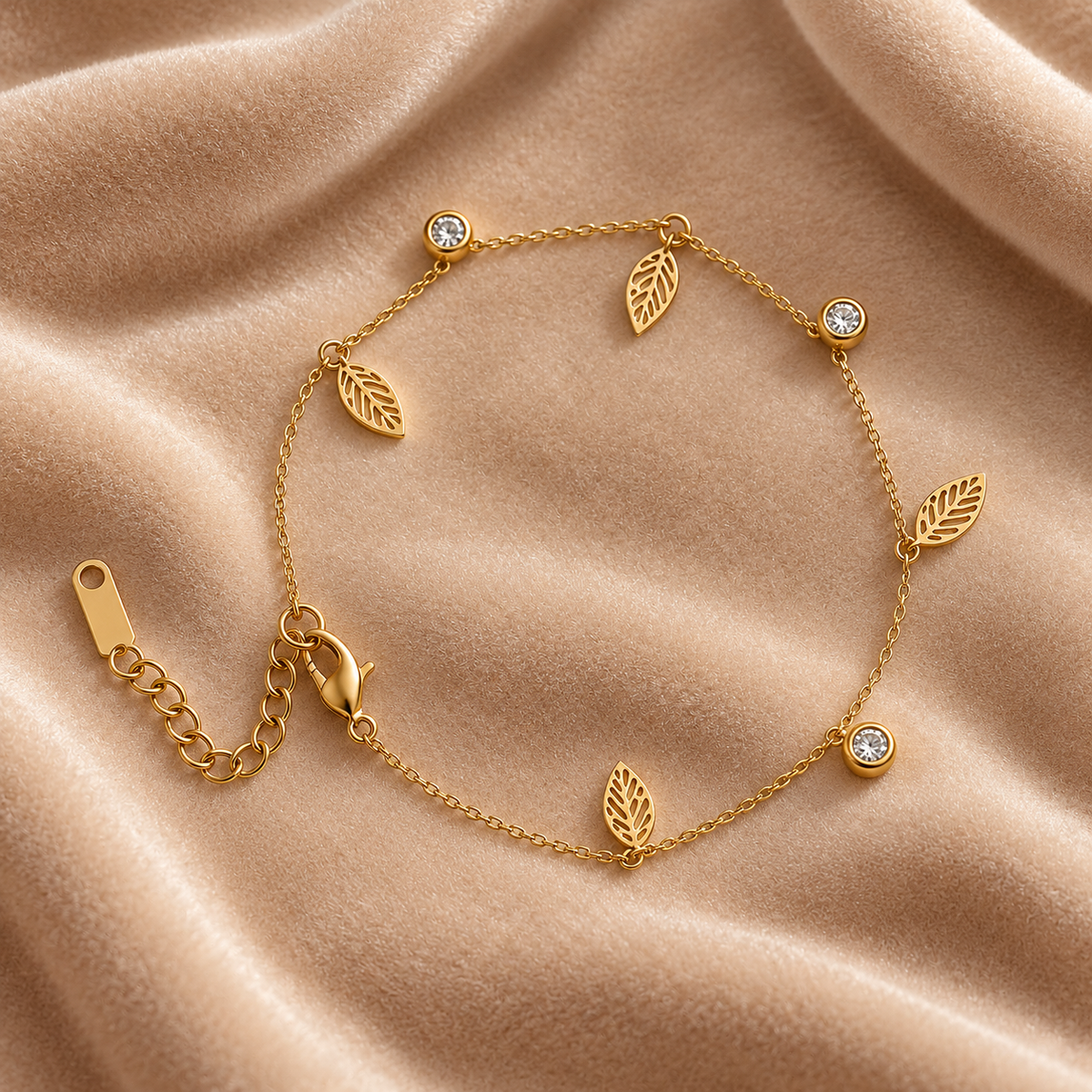 Gold Leaf Charm Bracelet with Crystal Accents on velvet