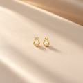 Delicate Gold Pearl Teardrop Earrings on flat lay
