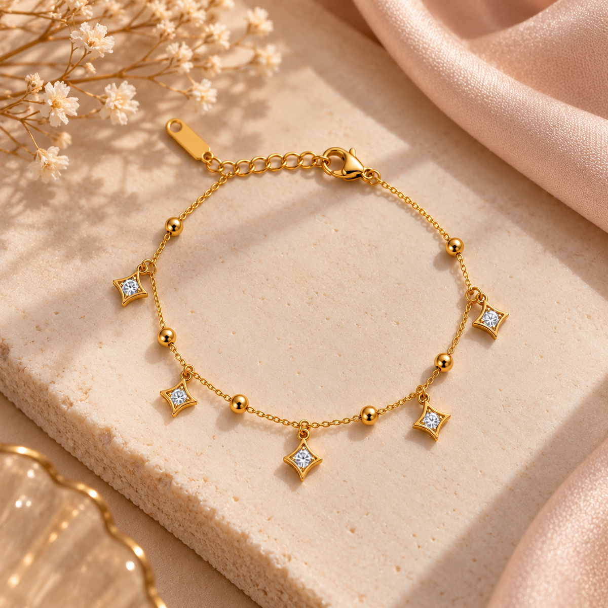 Gold Star Charm Bracelet with Crystal Accents on flat lay