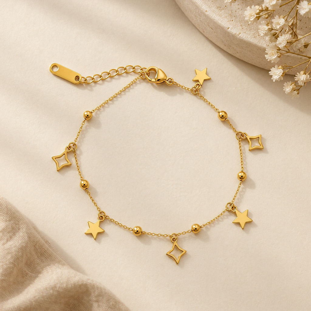 Gold Star and Geometric Charm Bracelet on flat lay