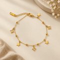 Gold Star and Geometric Charm Bracelet on flat lay