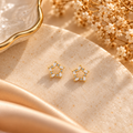 Delicate Gold Star Stud Earrings flat lay