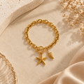 Gold-Tone Starfish & Seashell Charm Bracelet for Women on flat lay