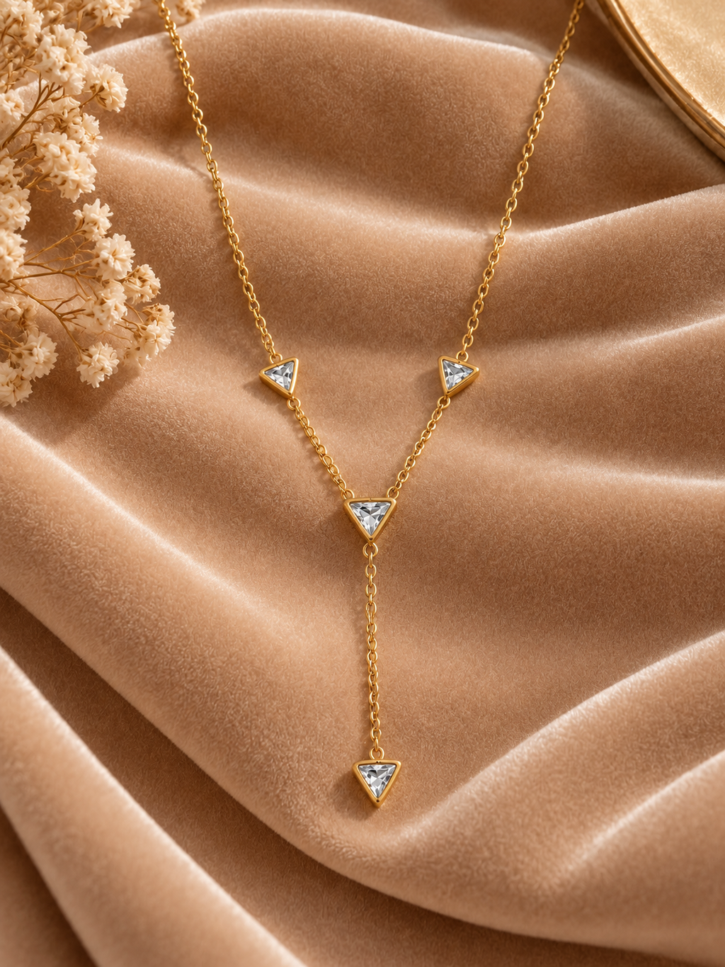 Gold Triangular Crystal Necklace on velvet
