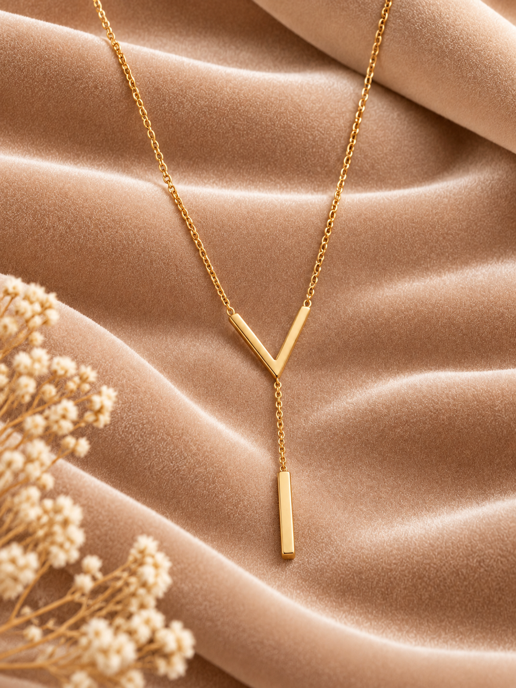 Minimalist Gold V-Bar Y-Chain Necklace on velvet
