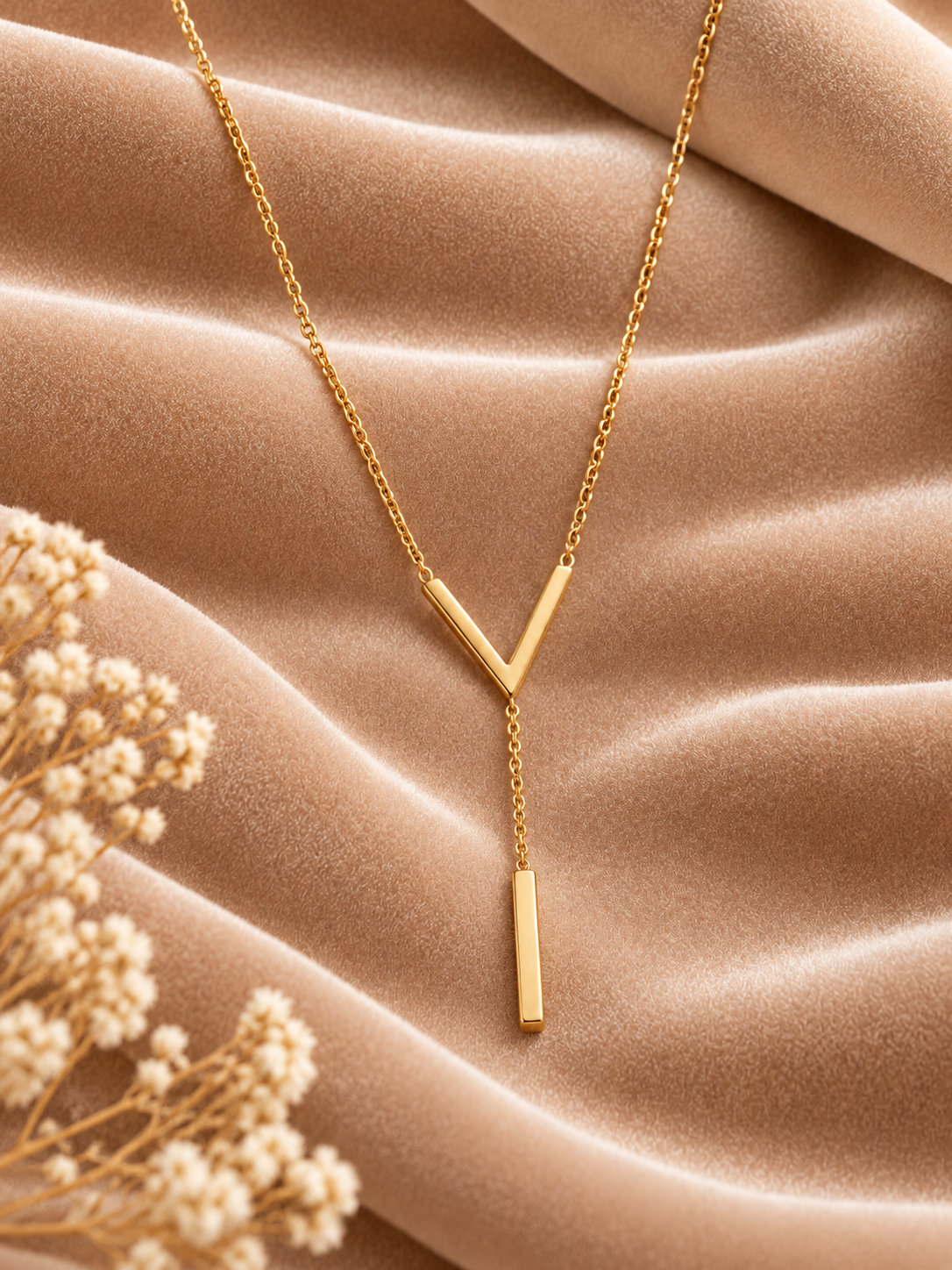 Minimalist Gold V-Bar Y-Chain Necklace on velvet
