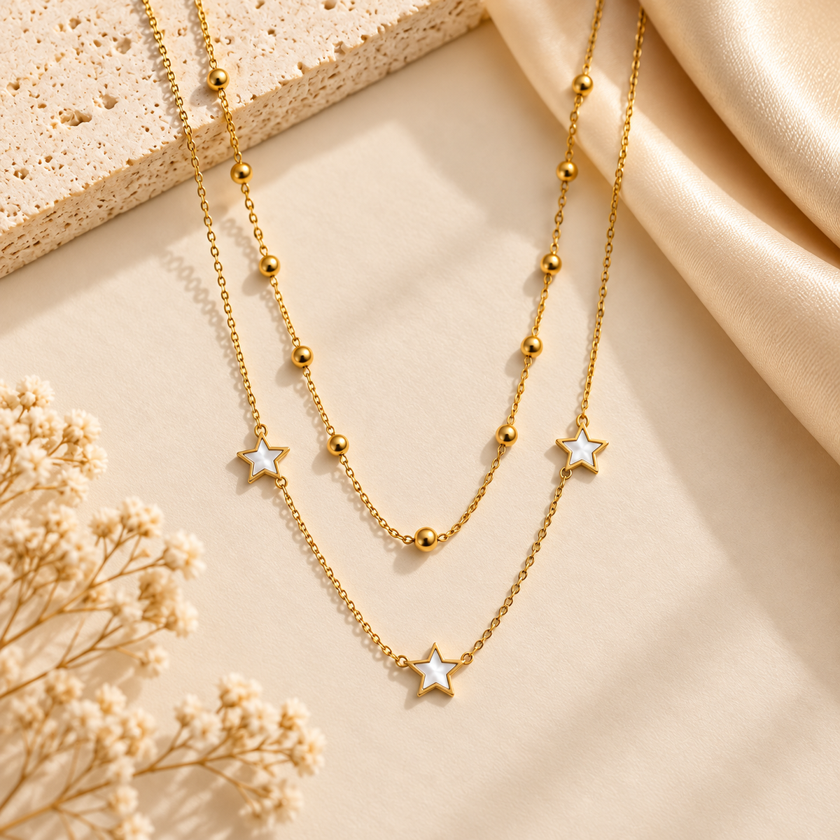 Layered Gold Star Necklace with Beaded Chain on flat lay

