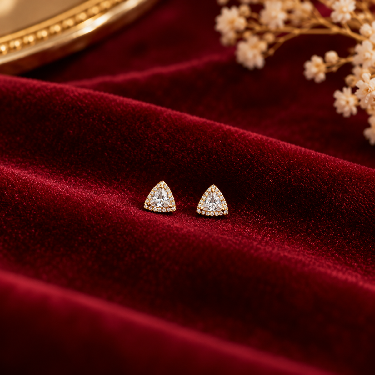 Gold Triangle Halo Stud Earrings on velvet